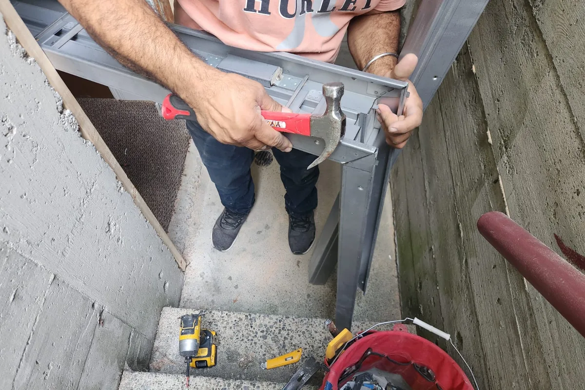 A+ Doors Inc technician installing a steel door frame in Vancouver